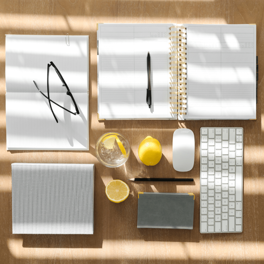 Creative workspace with planner, stationery and lemons, representing thoughtful brand refinement and business growth.